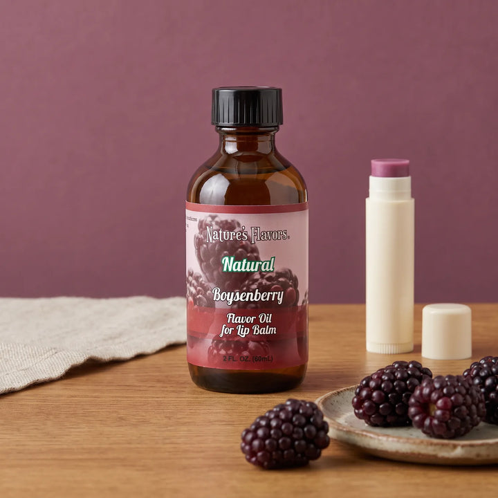 Nature's Flavors Boysenberry Flavor Oil for Lip Balm, 2 oz bottle with boysenberries and an open unbranded lip balm tube.