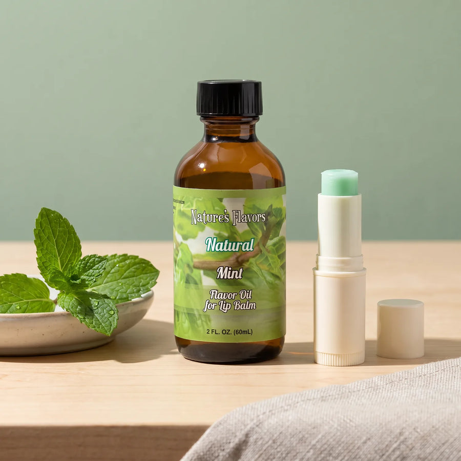 Nature's Flavors Mint Flavor Oil for Lip Balm, 2 oz bottle with mint leaves and an open unbranded lip balm tube.