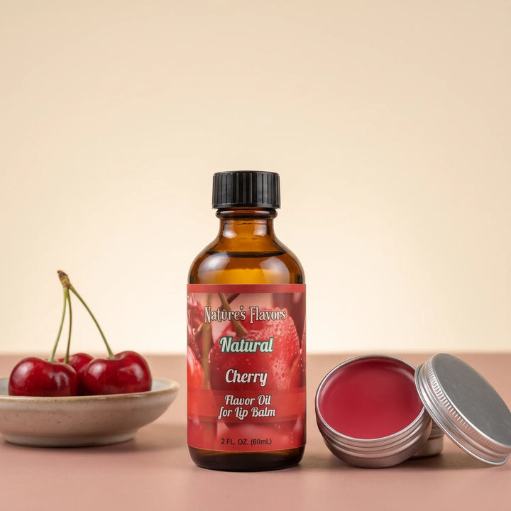 Nature's Flavors Cherry Flavor Oil for Lip Balm, 2 oz bottle with cherries and an open unbranded lip balm tin.