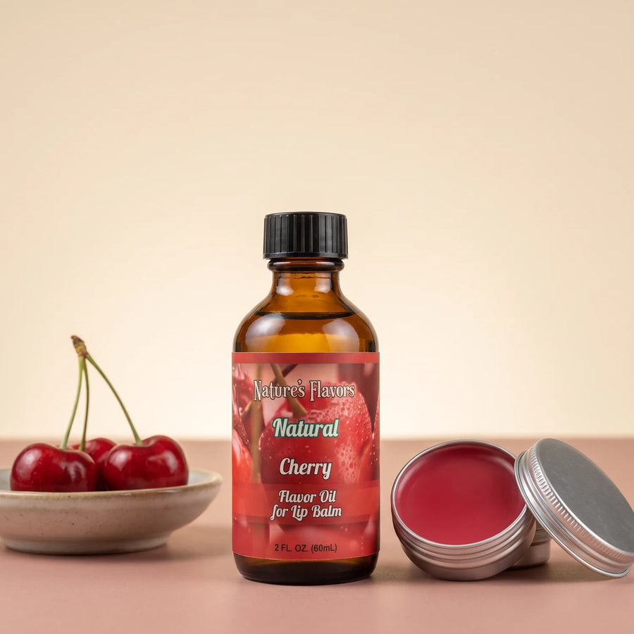 Nature's Flavors Cherry Flavor Oil for Lip Balm, 2 oz bottle with cherries and an open unbranded lip balm tin.