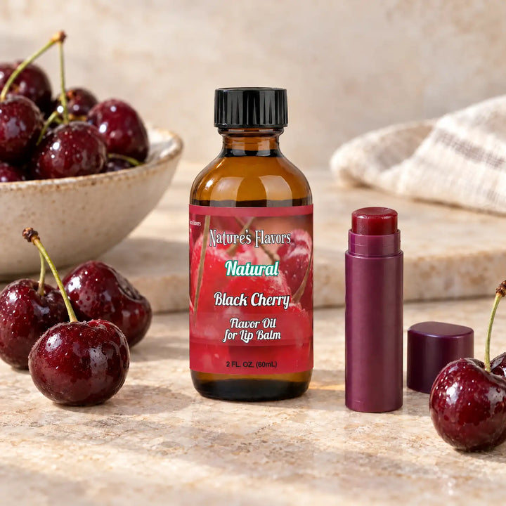 Nature's Flavors Black Cherry Flavor Oil for Lip Balm, 2 oz amber bottle with flavor-matched ingredients and an open lip balm.