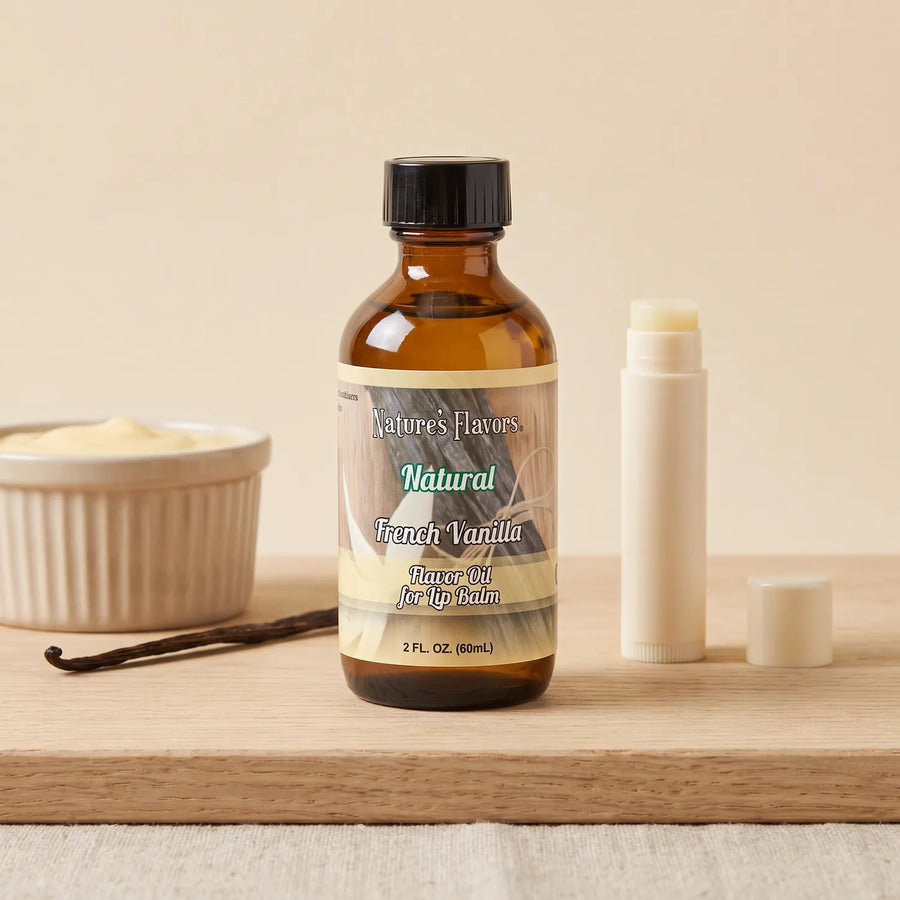 Nature's Flavors French Vanilla Flavor Oil for Lip Balm, 2 oz bottle with vanilla custard and an open unbranded lip balm tube.