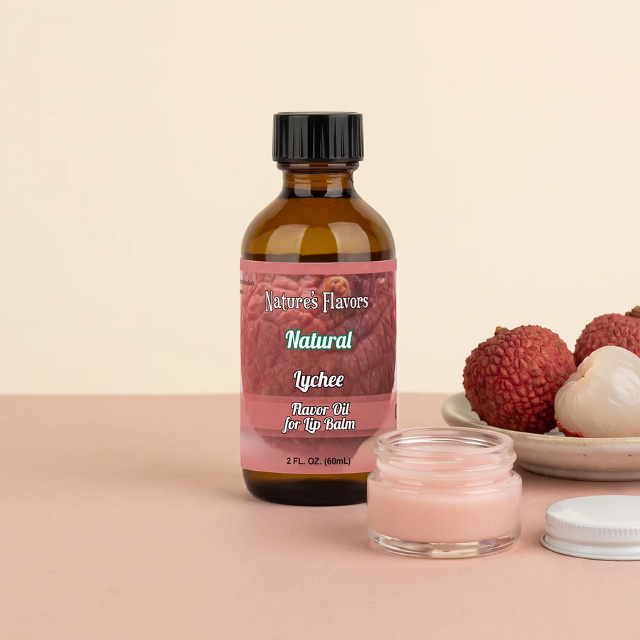 Nature's Flavors Lychee Flavor Oil for Lip Balm, 2 oz bottle with lychees and an open unbranded lip balm jar.