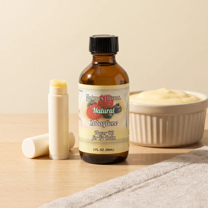 Nature's Flavors Zabaglione Flavor Oil for Lip Balm, 2 oz bottle with custard and an open unbranded lip balm tube.
