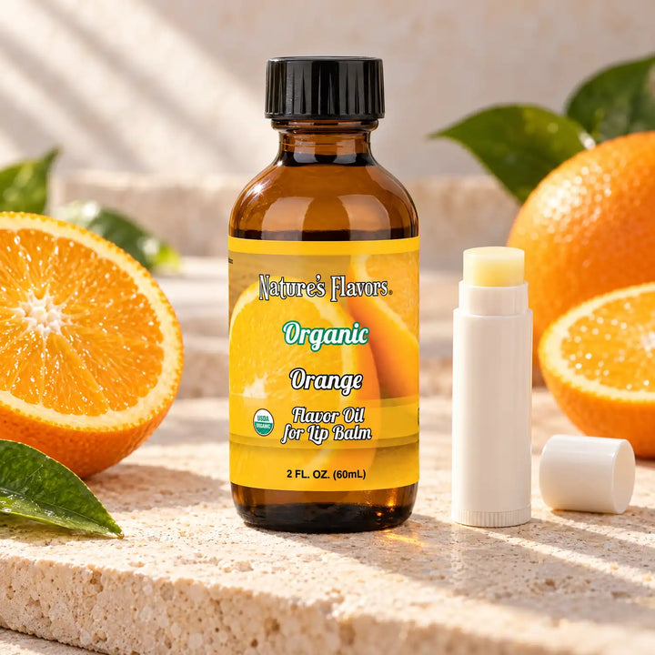 Nature's Flavors Organic Orange Flavor Oil for Lip Balm, 2 oz amber bottle with flavor-matched ingredients and an open lip balm.