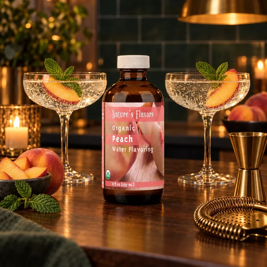 8 oz bottle of Nature's Flavors Organic Peach Water Flavoring between two evening mocktail glasses with peach slices