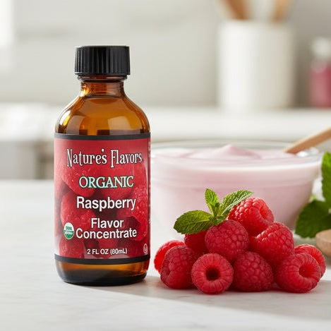 Bottle of Nature's Flavors Organic Raspberry Flavor Concentrate with fresh raspberries on a light surface.