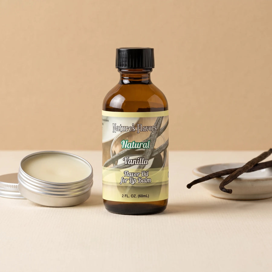 Nature's Flavors Vanilla Flavor Oil for Lip Balm, 2 oz bottle with vanilla pods and an open unbranded lip balm tin.