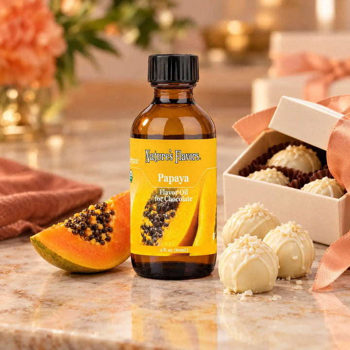 Nature's Flavors Organic Papaya Flavor Oil For Chocolate, 2-ounce bottle, with papaya and white chocolate truffles.