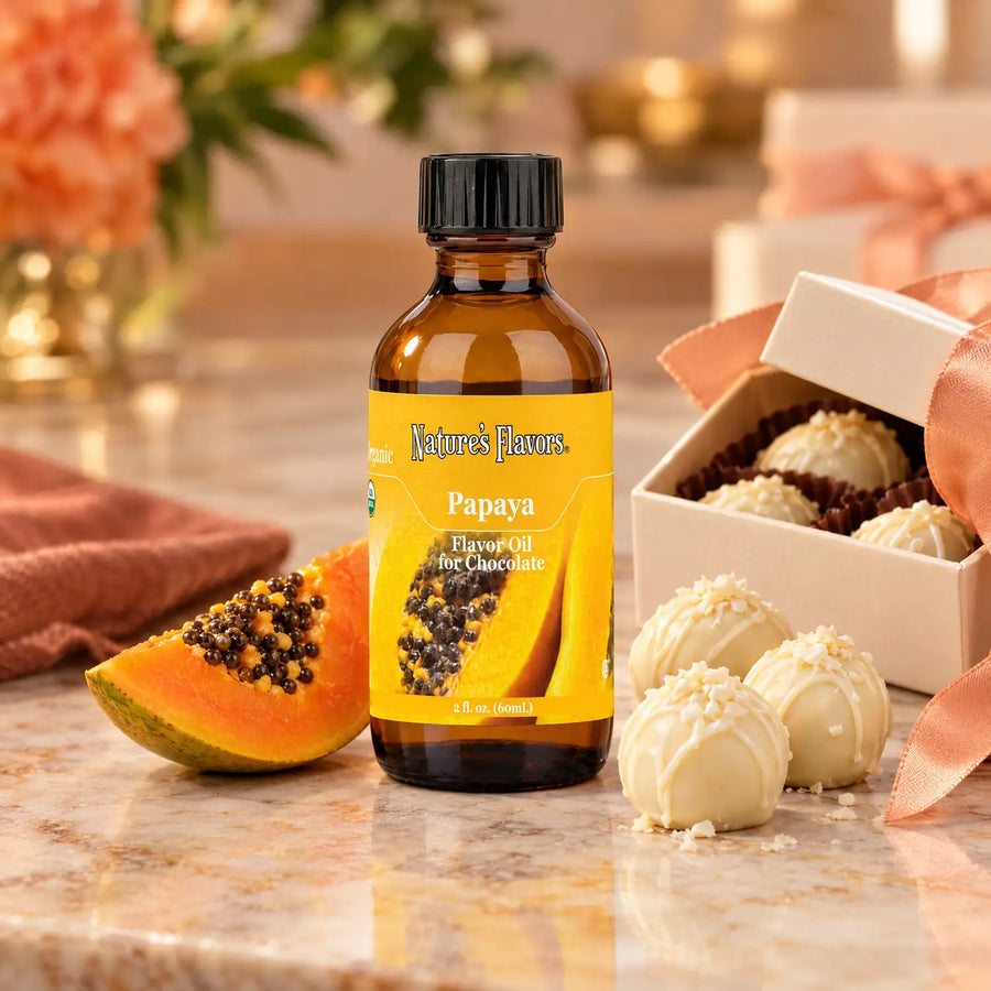 Nature's Flavors Organic Papaya Flavor Oil For Chocolate, 2-ounce bottle, with papaya and white chocolate truffles.