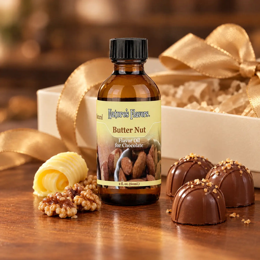 Nature's Flavors Butter Nut Flavor Oil for Chocolate, 2-ounce bottle, with butter, walnuts and boxed chocolate bonbons.