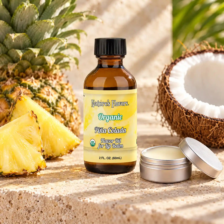 Nature's Flavors Organic Pina Colada Flavor Oil for Lip Balm, 2 oz amber bottle with flavor-matched ingredients and an open lip balm.
