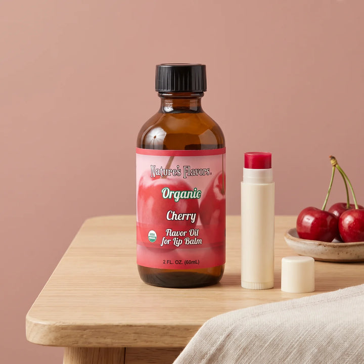 Nature's Flavors Organic Cherry Flavor Oil for Lip Balm, 2 oz bottle with cherries and an open unbranded lip balm tube.
