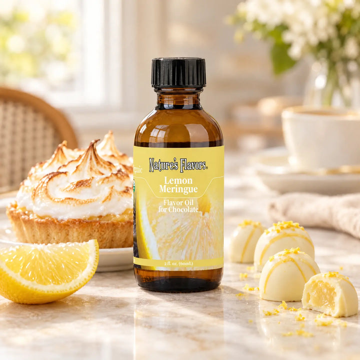 Nature's Flavors Organic Lemon Meringue Flavor Oil For Chocolate, 2-ounce bottle, with lemon meringue tart and white chocolate bonbons.