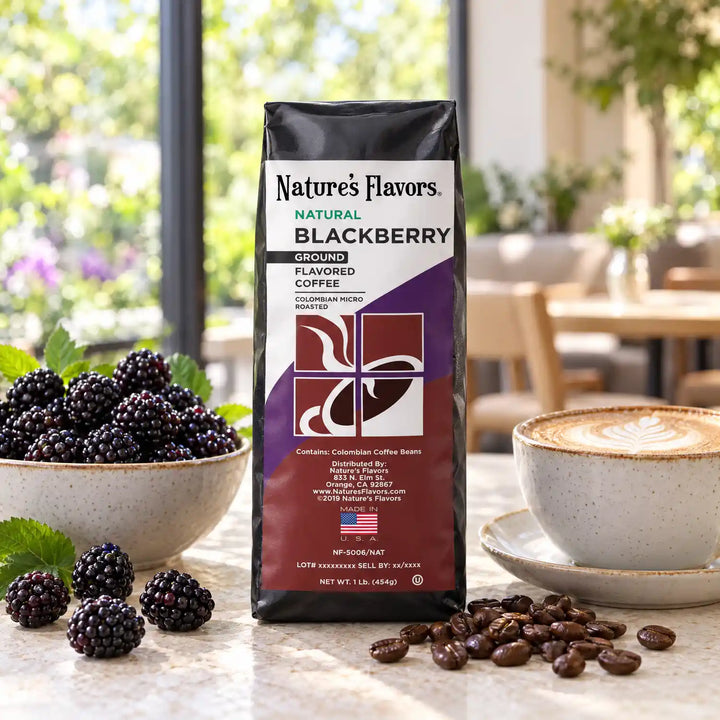Nature’s Flavors Blackberry Flavored Coffee Beans, 1 lb. Ground, in a black labeled bag with whole roasted coffee beans and a filled coffee drink in a bright garden-window coffee shop.