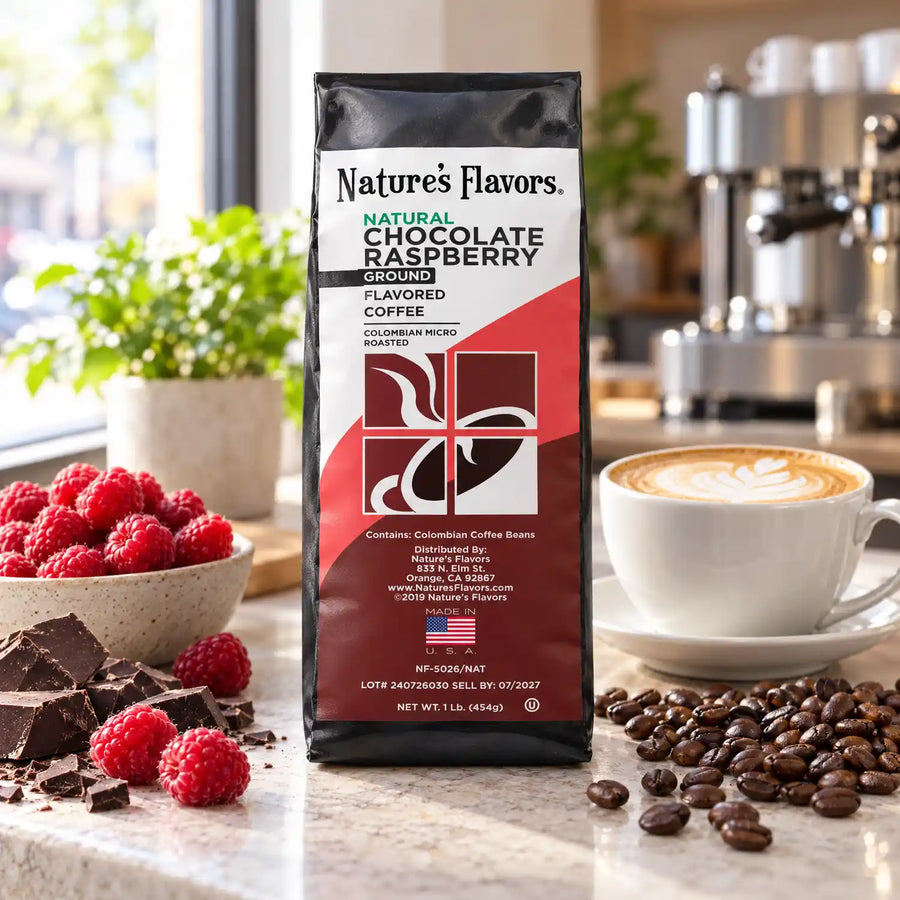Nature’s Flavors Chocolate Raspberry Flavored Coffee Beans, 1 lb. Ground, in a black labeled bag with whole roasted coffee beans and a filled coffee drink in a bright neighborhood coffee shop.