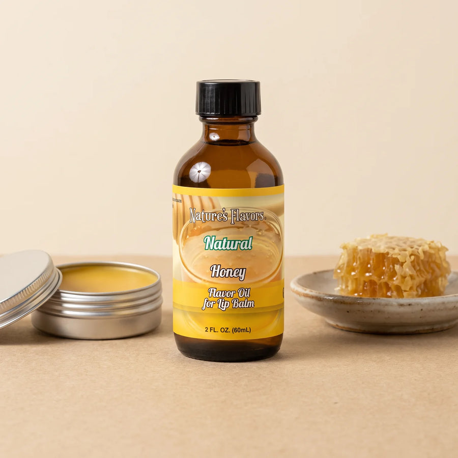 Nature's Flavors Honey Flavor Oil for Lip Balm, 2 oz bottle with honeycomb and an open unbranded lip balm tin.
