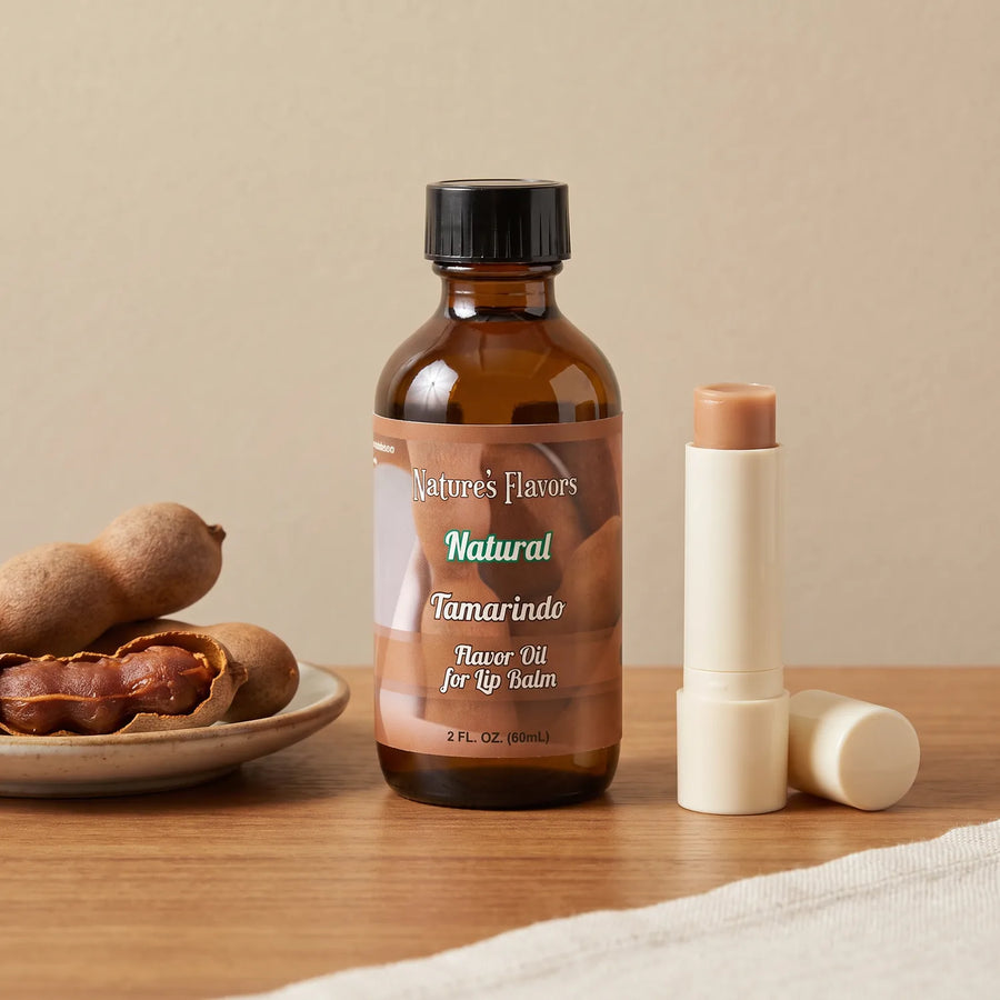 Nature's Flavors Tamarindo Flavor Oil for Lip Balm, 2 oz bottle with tamarind and an open unbranded lip balm tube.