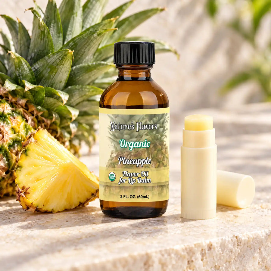 Nature's Flavors Organic Pineapple Flavor Oil for Lip Balm, 2 oz amber bottle with flavor-matched ingredients and an open lip balm.