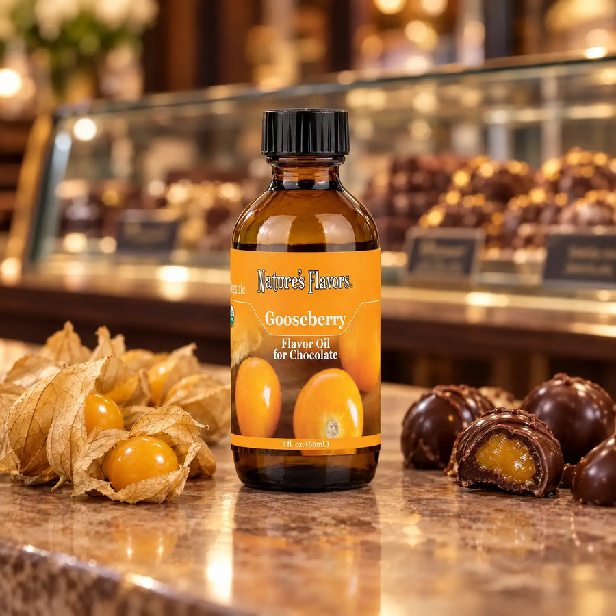 Nature's Flavors Organic Gooseberry Flavor Oil For Chocolate, 2-ounce bottle, with golden gooseberries and dark chocolate bonbons.