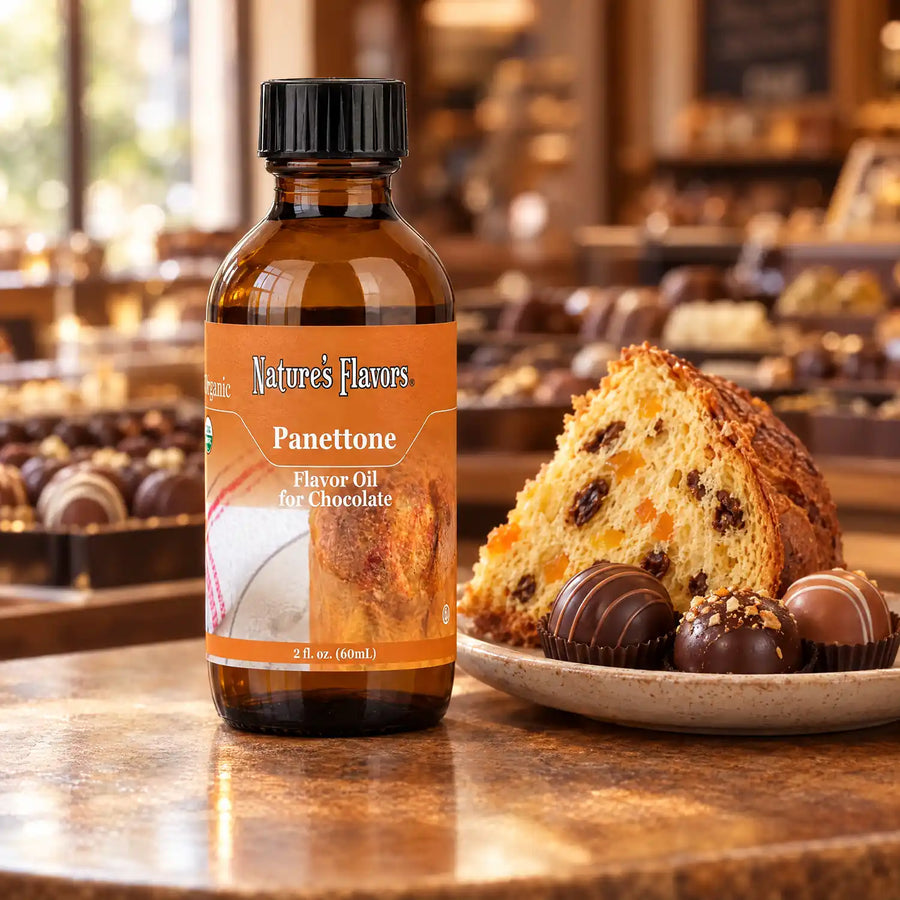 Nature's Flavors Organic Panettone Flavor Oil For Chocolate, 2-ounce bottle, with panettone and chocolate bonbons.