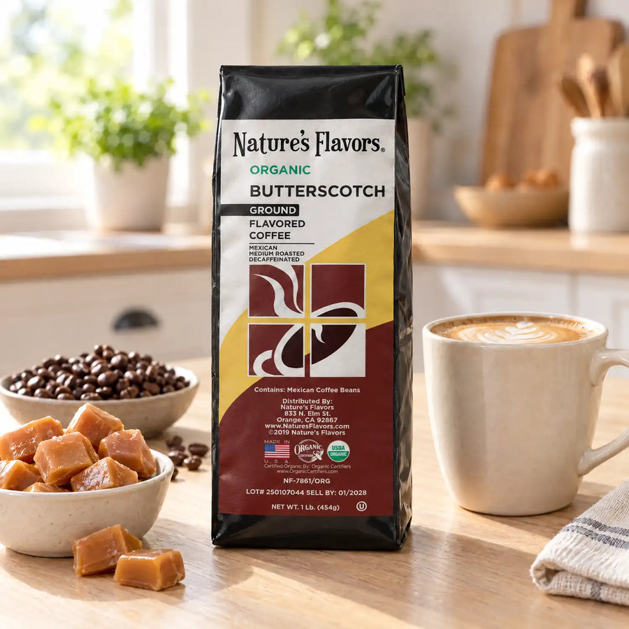 Nature’s Flavors Organic Decaf Butterscotch Flavored Coffee Beans, 1 lb. Ground, in a black labeled bag with whole roasted coffee beans and a filled coffee drink in the retained bright scene.