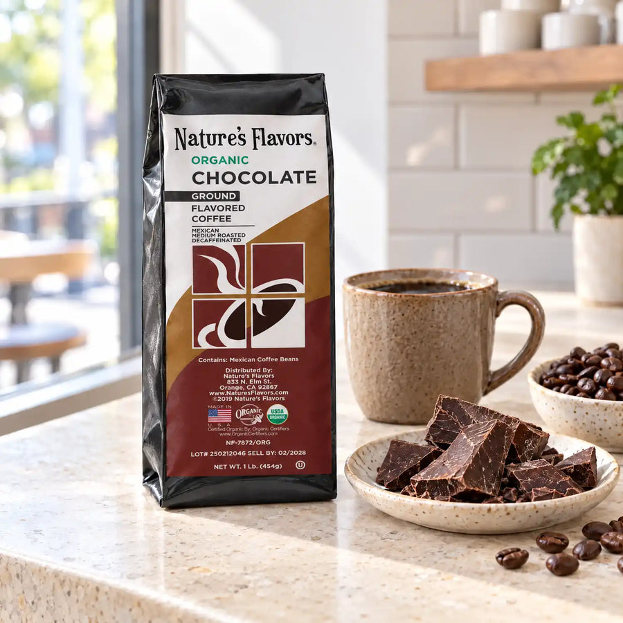 Nature’s Flavors Organic Decaf Chocolate Flavored Coffee Beans, 1 lb. Ground, in a black labeled bag with whole roasted coffee beans and a filled coffee drink in the retained bright scene.