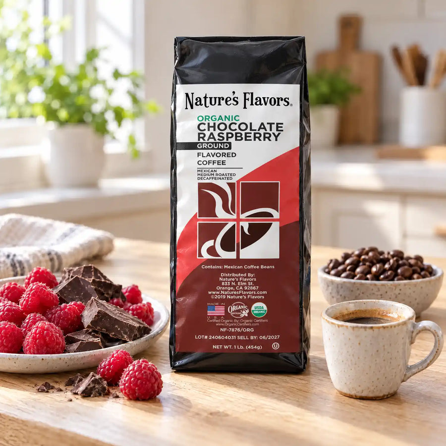 Nature’s Flavors Organic Decaf Chocolate Raspberry Flavored Coffee Beans, 1 lb. Ground, in a black labeled bag with whole roasted coffee beans and a filled coffee drink in the retained bright scene.