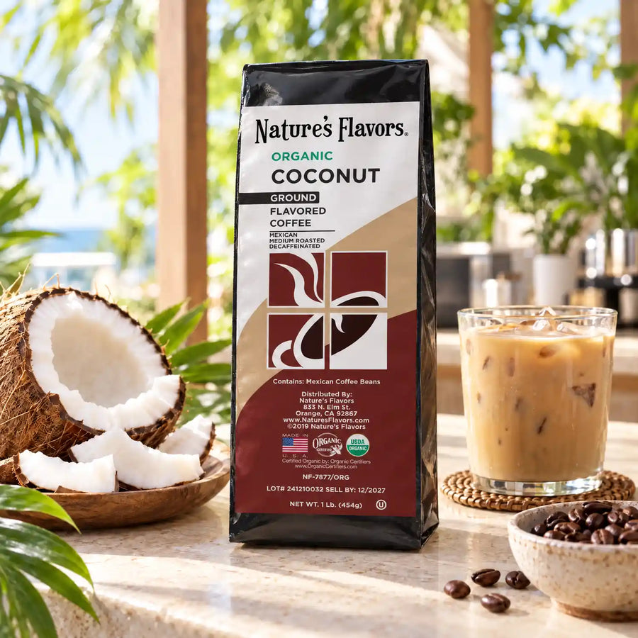Nature’s Flavors Organic Decaf Coconut Flavored Coffee Beans, 1 lb. Ground, in a black labeled bag with whole roasted coffee beans and a filled coffee drink in the retained bright scene.