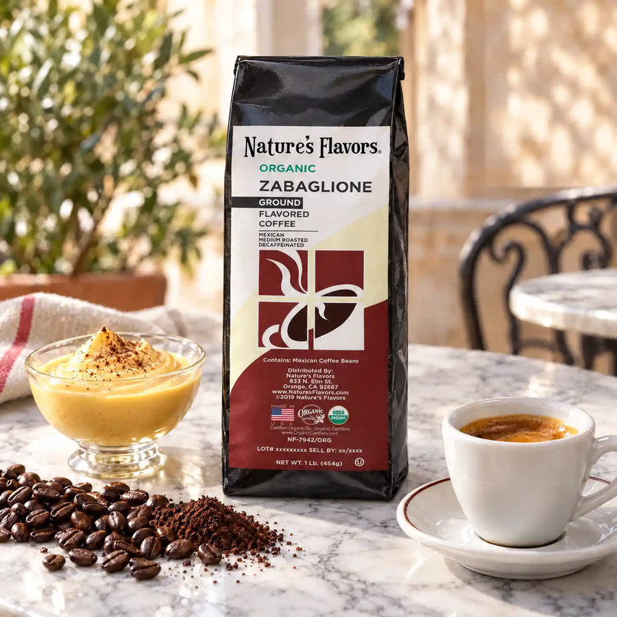 Nature’s Flavors Organic Decaf Zabaglione Flavored Coffee Beans, 1 lb. Ground, beside flavor cues, roasted coffee beans, grounds and a filled coffee drink in a bright lifestyle scene.