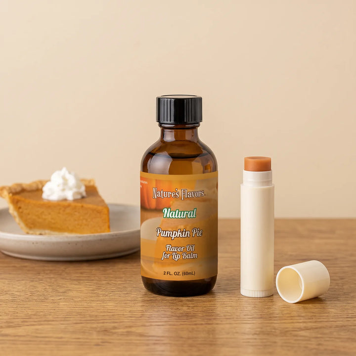 Nature's Flavors Pumpkin Pie Flavor Oil for Lip Balm, 2 oz bottle with pumpkin pie and an open unbranded lip balm tube.