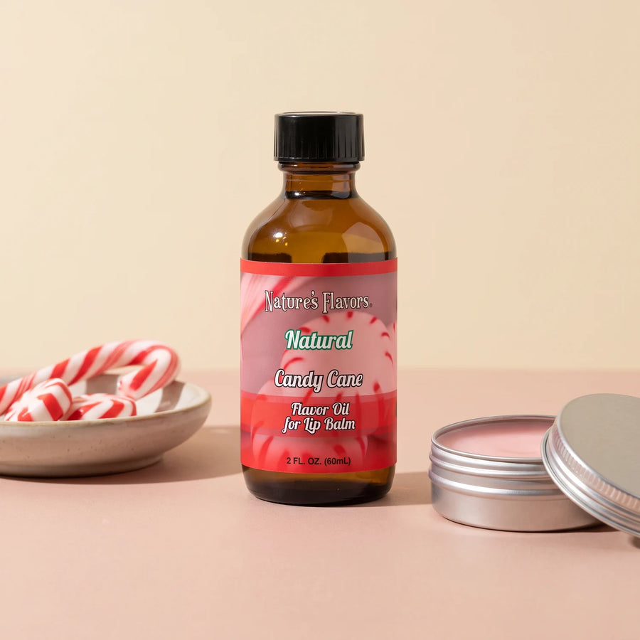 Nature's Flavors Candy Cane Flavor Oil for Lip Balm, 2 oz bottle with candy cane and an open unbranded lip balm tin.
