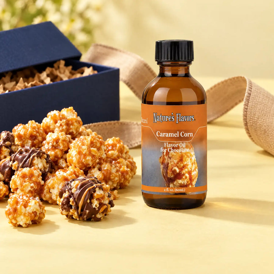 Nature's Flavors Caramel Corn Flavor Oil for Chocolate, 2-ounce bottle, with caramel popcorn and chocolate popcorn clusters on a gift table.