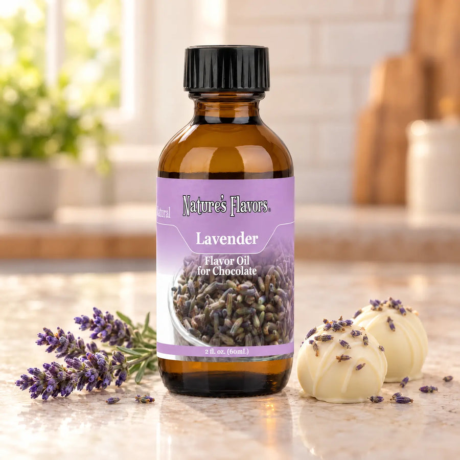 Nature's Flavors Lavender Flavor Oil for Chocolate bottle beside lavender sprigs and white chocolate truffles on a light countertop.