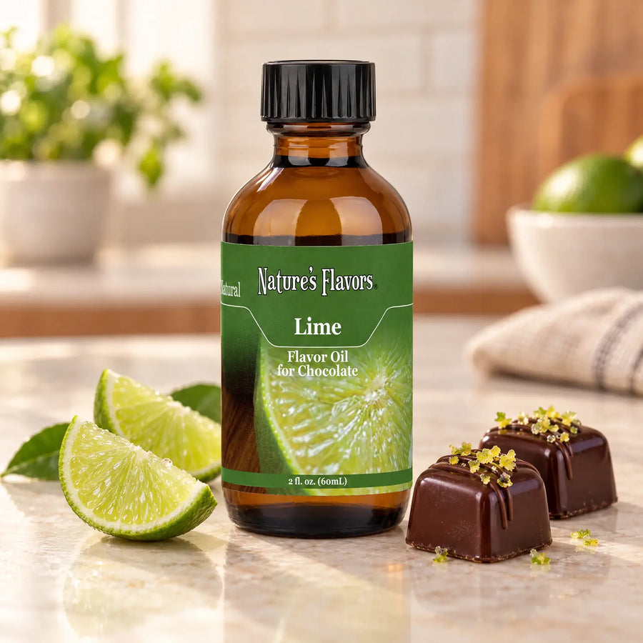 Nature's Flavors Lime Flavor Oil for Chocolate bottle beside lime wedges and dark chocolate bonbons on a light countertop.