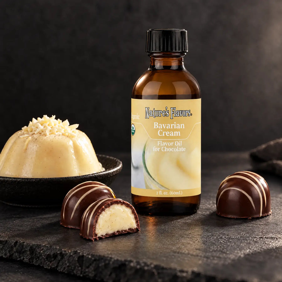 Nature's Flavors Organic Bavarian Cream Flavor Oil For Chocolate, 2-ounce bottle, with Bavarian cream and cream-filled chocolates on slate.