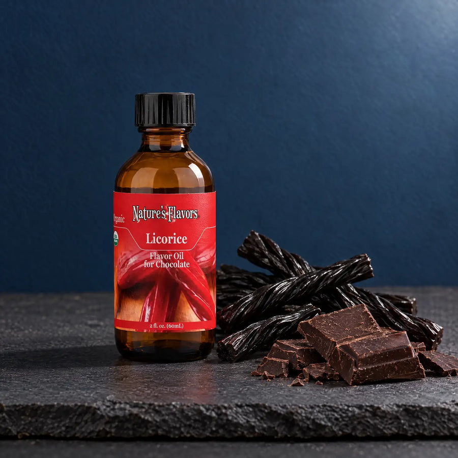Nature's Flavors Organic Licorice Flavor Oil For Chocolate, 2-ounce bottle, with licorice twists and dark chocolate on slate.