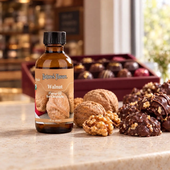 Nature's Flavors Organic Walnut Flavor Oil For Chocolate, 2-ounce bottle, with walnuts and chocolate clusters in a chocolate shop.