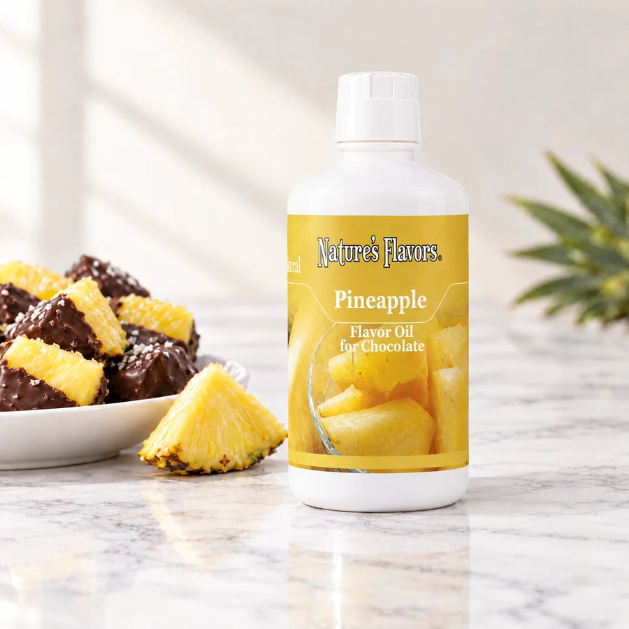 Nature's Flavors Pineapple Flavor Oil for Chocolate, 32-ounce bottle, with pineapple and chocolate-dipped pineapple on marble.