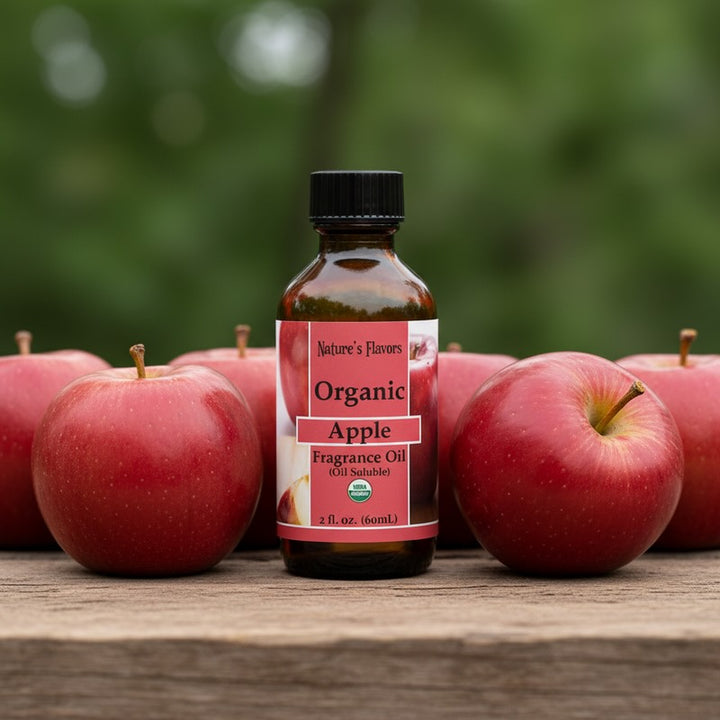 Bottle of Organic Apple fragrance oil with apples on a wooden surface