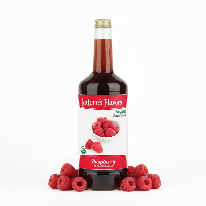 Bottle labeled, "Organic Flavor Syrup Raspberry" next to two groups of raspberries. 