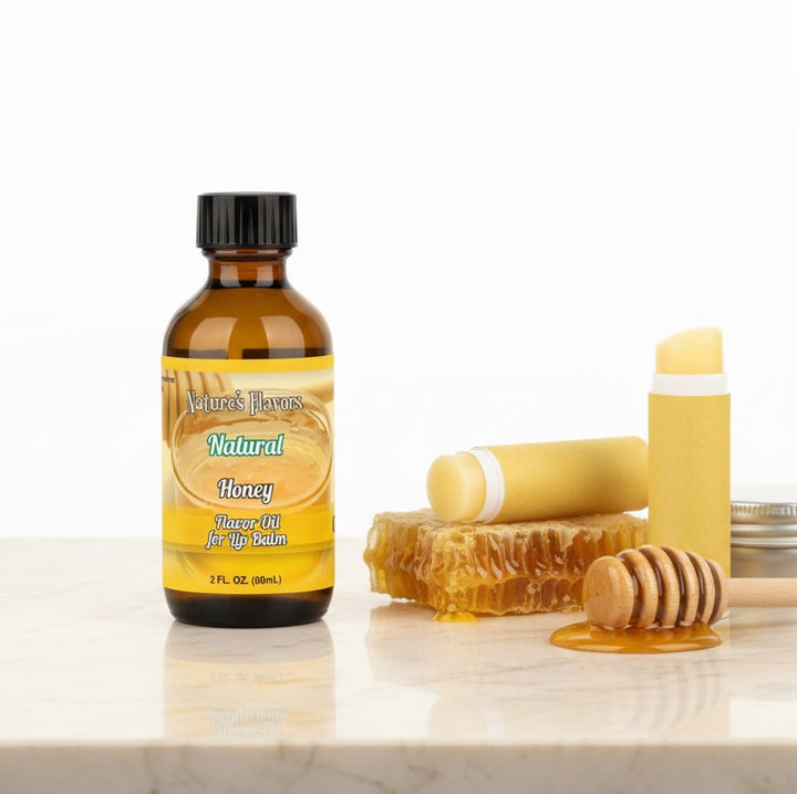 Bottle of Nature's Flavors Natural Honey Flavor Oil with honeycomb and honey dipper on a white background